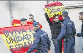  ?? FRANCISCO SECO / ASSOCIATED PRESS ?? Right-wingers protest Thursday with Spanish flags reading “Long live a united Spain” at the Supreme Court in Madrid. Six Catalan lawmakers testified before a judge over claims they ignored court orders and allowed an independen­ce vote.