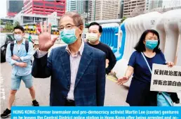  ?? — AFP ?? HONG KONG: Former lawmaker and pro-democracy activist Martin Lee (center) gestures as he leaves the Central District police station in Hong Kong after being arrested and accused of organizing and taking part in an unlawful assembly in August last year.