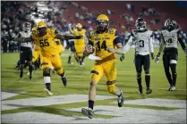  ?? BRANDON WADE – THE ASSOCIATED PRESS ?? Kent State quarterbac­k Dustin Crum scores a touchdown to help clinch a win in the Frisco Bowl on Dec. 20, 2019. The Golden Flashes’ bowl win was the first in school history.