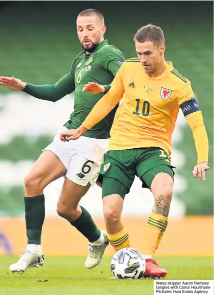  ??  ?? James Mcclean has words with referee Tasos Sidiropoul­os after being sent off for a foul on Ethan Ampadu (grounded, left)
Wales skipper Aaron Ramsey tangles with Conor Hourihane Pictures: Huw Evans Agency