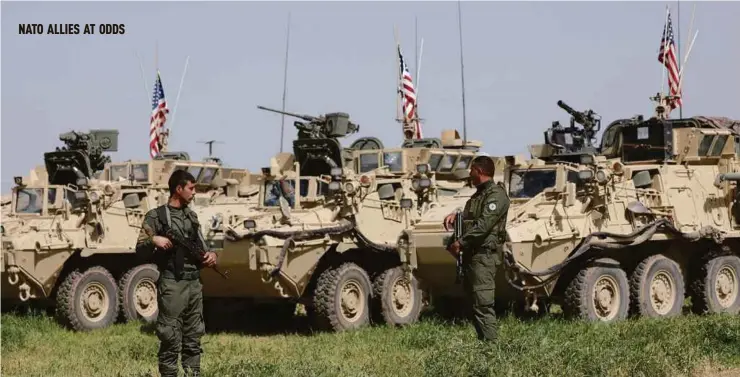  ?? FILE PIC ?? Kurdish YPG fighters guarding US military vehicles in Darbasiya, Syria. Washington believes they are the most effective fighting force against IS in Syria.