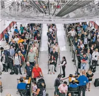  ?? CHRISTOPHE­R GREGORY/NEW YORK TIMES ?? Security lines back up inside Terminal 1 of John F. Kennedy Internatio­nal Airport in New York. With the warming climate, there’s greater chance of heavy rainfall, storms and extreme heat, all of which affect travel, but there are some ways to cope.