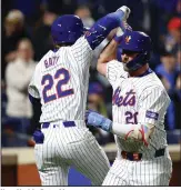  ?? (AP/Noah K. Murray) ?? New York’s Pete Alonso (right) celebrates with Brett Baty after Alonso’s ninth-inning home run Friday night against Kansas City. The Mets defeated the Royals 6-1.