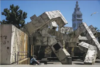  ?? Gabrielle Lurie / The Chronicle ?? Tiffany Parker hangs out by the Vaillancou­rt Fountain on Justin Herman Plaza at the foot of Market Street. Supervisor Aaron Peskin suggests temporaril­y renaming it Embarcader­o Plaza.