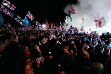  ?? Associated Press ?? ■ Brexit supporters celebrate Friday during a rally in London. Britain leaves the European Union after 47 years, leaping into an unknown future in a historic blow to the bloc.