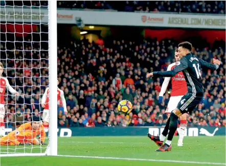  ?? — AFP ?? Manchester United’s Jesse Lingard (right) scores in their English Premier League match against Arsenal at the Emirates Stadium in London on Saturday. Man United won 3-1.