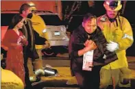  ?? RMG News ?? FIRST RESPONDERS help people injured in a shooting at Star Ballroom Dance Studio in Monterey Park on Saturday.