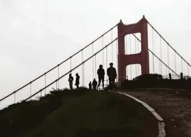  ?? Scott Strazzante / The Chronicle ?? Tourists visit the Marin Headlands overlookin­g the Golden Gate Bridge in Sausalito on Sunday. A slow-moving system will bring more rain next week.