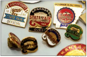  ?? Arkansas Democrat-Gazette/CARY JENKINS ?? These are pins from the Arkansas State Fair and Livestock Show, which turns 80 this year.