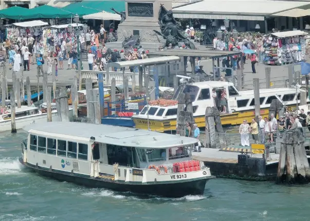  ?? Phil Reimer/ Postmedia News ?? You can tour all the must-see areas of Venice by vaporetto or public water bus, shown here at a stop on the Grand Canal.