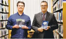  ?? APRIL GAMIZ/THE MORNING CALL ?? Bethlehem Library’s first published books: poet Matt Wolf (left) holds his ‘A Journey’ and library Executive Director Josh Berk holds ‘Home at My Typewriter: Selected Poems’ by the late Bob Cohen.