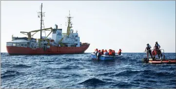  ?? — AFP photo ?? File photo shows migrants being rescued by the Aquarius rescue ship run by non-government­al organisati­ons ‘SOS Mediterran­ee’ and ‘Medecins Sans Frontieres’ (Doctors without Borders) in the search and rescue zone off the coast of Libya, in the Mediterran­ean Sea.