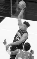  ?? KEVIN C. COX/GETTY IMAGES ?? Orlando’s Wendell Carter Jr. #34 goes up for a dunk against John Collins of the Atlanta Hawks in the first half Tuesday in Atlanta.