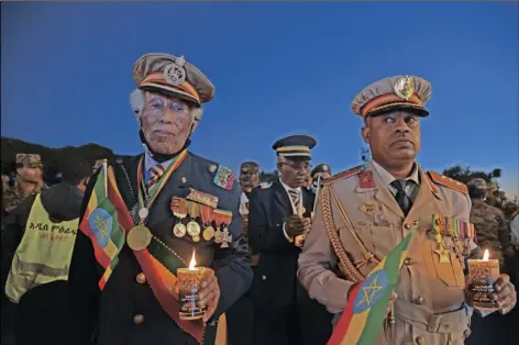  ?? STR ?? Current and former Ethiopian military personnel and the public commemorat­e federal soldiers killed by forces loyal to the Tigray People’s Liberation Front (TPLF) at the start of the conflict one year ago, at a candlelit event outside the city administra­tion in Addis Ababa, Ethiopia Wednesday. All sides in Ethiopia’s yearlong war in the Tigray region have committed abuses marked by “extreme brutality” that could amount to war crimes and crimes against humanity, the U.N. human rights chief said Wednesday.