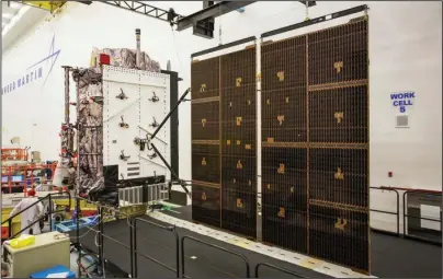  ?? The Associated Press ?? CLEAN ROOM: This June 23 photo provided by Lockheed Martin shows the second GPS III satellite during testing of the deployment of its solar arrays in a clean room at Lockheed Martin’s complex south of Denver. The first GPS III satellite is scheduled to be launched from Cape Canaveral, Fla., on Tuesday.