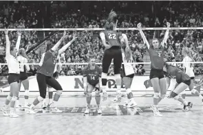  ?? ADAM CAIRNS/COLUMBUS DISPATCH ?? Wisconsin celebrates its five-set victory over Louisville, which entered the NCAA volleyball final four as the previously unbeaten No. 1 seed.