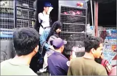  ?? SUPPLIED ?? Cambodian migrant workers get out of a truck after they were deported by Thai authoritie­s on Friday.