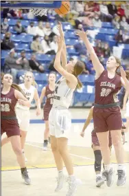  ?? Neal Denton/The Baxter Bulletin ?? Siloam Springs sophomores Brooke Ross, left, and Brooke Smith, right, defend on the play as Mountain Home’s Emma Wilber shoots Friday night in Mountain Home. Siloam Springs defeated Mountain Home 40-37.