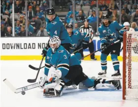  ?? Josie Lepe / Associated Press ?? Sharks goaltender Martin Jones stops a first-period shot against the Flames at SAP Center. Jones finished with 29 saves as San Jose stopped a two-game slide.