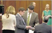  ?? Stan Carroll/the Commercial Appeal ?? Former Southaven mayor Greg Davis (second from left) confers with members of his defense team tuesday, the second day of his embezzleme­nt trial.