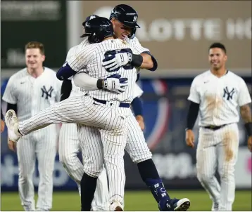  ?? FRANK FRANKLIN II — THE ASSOCIATED PRESS ?? The Yankees’ Aaron Judge hugs Jose Trevino, front, after Trevino hit a single to drive in the winning run in the 11th inning.