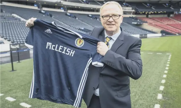  ??  ?? At his unveiling at Hampden Park yesterday, Alex Mcleish vowed to win over those among the Tartan Army who are dubious about his re-appointmen­t as Scotland boss.