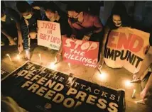  ?? AARON FAVILA/AP ?? Activists light candles as they condemn the killing of Filipino journalist Percival Mabasa during a rally in Quezon City, Philippine­s, on Oct. 4. The Philippine­s is considered one of the world’s most dangerous countries for journalist­s.