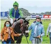  ?? | CHASE LIEBENBERG ?? WARRIOR is congratula­ted by jockey Richard Fourie, while owner Belinda Kieswetter (left) and trainer Justin Snaith express their delight.