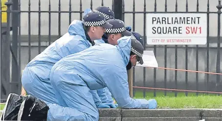  ?? Picture: PA. ?? Police forensic officers search Parliament Square the day after the terrorist attack. Eight people have been arrested in raids by police and intelligen­ce agencies in connection with the atrocity.