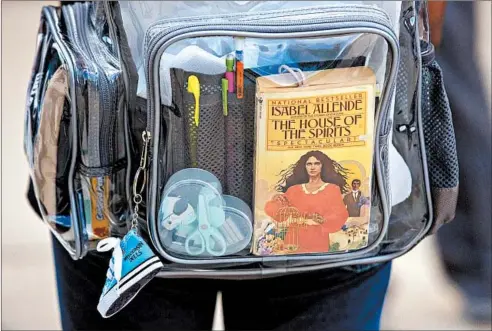  ?? CAMILLE FINE/CHICAGO TRIBUNE ?? A student carrying a clear backpack leaves Gary Elementary School in Chicago’s Little Village neighborho­od in September 2019.