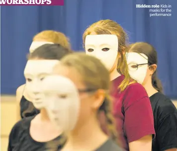  ??  ?? Hidden role Kids in masks for the performanc­e