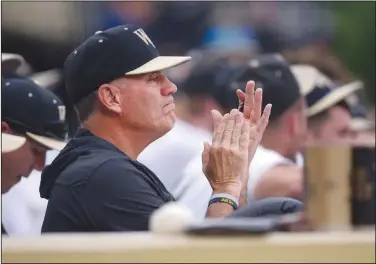  ?? Associated Press ?? In the dugout: Wake Forest head coach Tom Walter encourages his Deacons in their 7-5 win over Virginia Tech in an NCAA college baseball game last month at Couch Field in Winston-Salem, N.C. Baseball has often played a secondary role during his 27-year career even though he has won more than 800 games and taken three different schools to the national tournament.