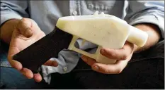  ?? JAY JANNER / AMERICANST­ATESMAN ?? This plastic pistol was made on a 3D-printer at a home in Austin, Texas. A company wants to make the blueprint available to download.