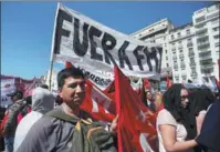  ?? AGUSTIN MARCARIAN / REUTERS ?? Demonstrat­ors gather in front of the National Congress in Buenos Aires on Sept 18 as Argentine lawmakers approved an “emergency food” bill. The placard reads: “IMF go out”.