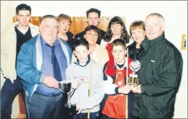  ?? ?? Dick Caplice (front left) presenting the Sean Caplice Memorial Cup to U21 tournament winner, Alan Baragry at Fermoy Snooker Club in March 2002. While runner-up, Eoin Callanan receives his prize from Michael Caplice. Also present are other members of the Caplice family, who attended the presentati­on ceremony in Fermoy CYMS Hall - David, Mary Mee, Jason, Esther, Marianne and Dolores McCarthy.