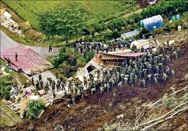  ?? REUTERS ?? Members of the Japan Self-Defense Forces (JSDF) search for survivors from a house damaged by a landslide caused by an earthquake in Atsuma town, Hokkaido, northern Japan, in this photo taken by Kyodo on Friday.