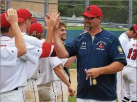  ?? AUSTIN HERTZOG - DIGITAL FIRST MEDIA ?? Spring City manager Mike Gancasz high-fives his players after the Red Sox won the Pa. Region 3 tournament Wednesday at Downingtow­n East High School.