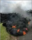  ?? MARCO GARCIA — THE ASSOCIATED PRESS ?? Lava burns across the road in the Leilani Estates in Pahoa, Hawaii, Saturday. Hundreds of anxious residents on the Big Island of Hawaii hunkered down Saturday for what could be weeks or months of upheaval as the dangers from an erupting Kilauea volcano...