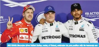  ??  ?? ABU DHABI: Mercedes driver Valtteri Bottas, center, of Finland, celebrates his pole position with his teammate second placed Lewis Hamilton, right, of Britain, and third placed Ferrari driver Sebastian Vettel, of Germany.— AP