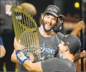  ?? Wally Skalij Los Angeles Times ?? DODGERS ace Clayton Kershaw finally secured that elusive World Series title but could move on in 2022.