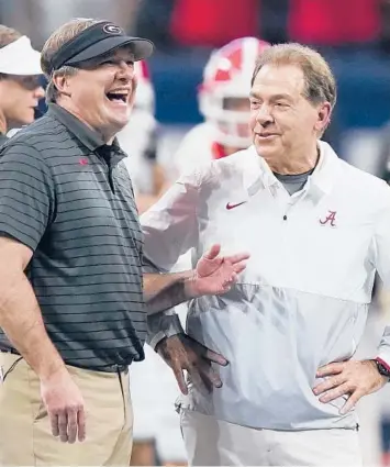  ?? APFILE ?? Georgia coach Kirby Smart and Alabama coach Nick Saban catch up before last month’s SEC championsh­ip game.