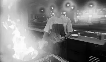  ??  ?? Chef Kramer prepares an order at Jianna, a farm-to-table Italian restaurant in Greenville. — WP-Bloombeg photos