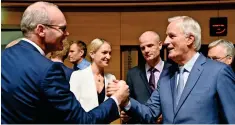  ?? AFP ?? DEAL STILL POSSIBLE: Irish Foreign Minister Simon Coveney shakes hands with EU negotiator Michel Barnier during a meeting in Luxembourg. —