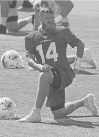  ?? JOEL AUERBACH/AP ?? Dolphins quarterbac­k Ryan Fitzpatric­k stretches during practice Friday in Davie, Fla.