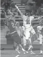  ?? SHANE FLANIGAN/THISWEEK ?? Olentangy Berlin’s Harrison Brewster makes a leaping catch past outstretch­ed Dublin Jerome defender Quinn Mccrab during a game Friday at Olentangy Berlin High School in Delaware.