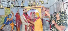  ?? PTI ?? Bride and groom wearing face masks perform rituals as they get married at Durga Temple during the ■
lockdown in Lucknow on Sunday.