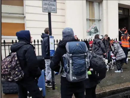  ??  ?? Evicted: Squatters leave a £15million Grade II listed mansion in Belgravia in February. It had been occupied by the Autonomous Nation of Anarchist Libertaria­ns