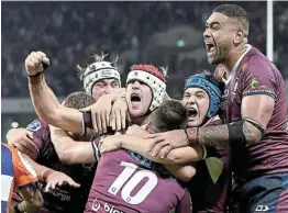  ?? Picture: GETTY IMAGES/BRADLEY KANARIS ?? SUPER VICTORY: James O’connor (No 10) of the Reds is congratula­ted by teammates after scoring the match-winning try during the Super Rugby AU final against the ACT Brumbies at Suncorp Stadium on Saturday in Brisbane.