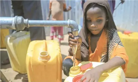  ?? — AFP ?? A Somali girl collects water from a well at the Tawakal IDP camp on the outskirts of Mogadishu, Somalia.