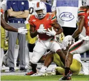  ?? AP ?? UM safety Jaquan Johnson (above, after an intercepti­on vs. Notre Dame on Nov. 11) thought about leaving for the NFL, but the team MVP will return for his senior season.